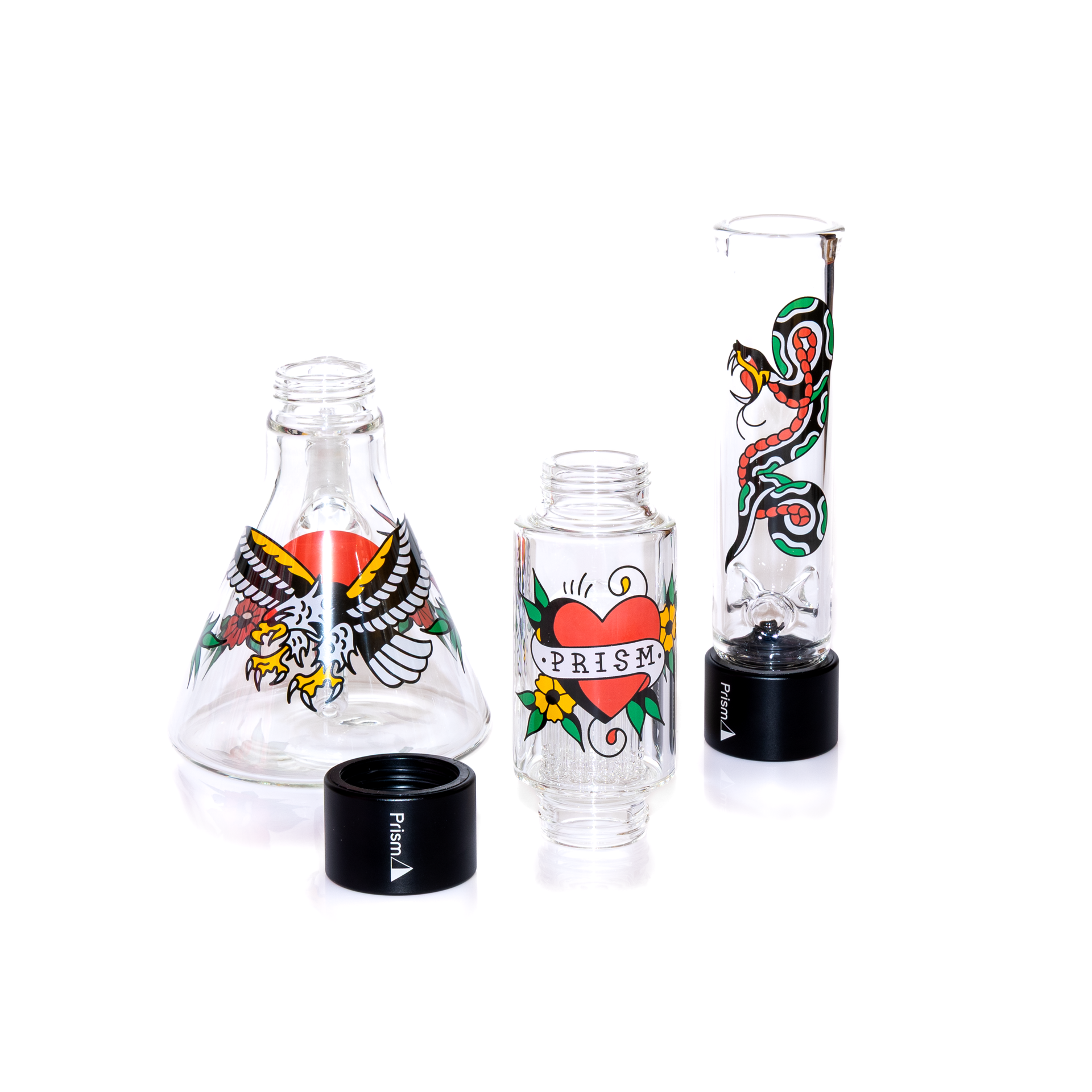 The Inked Double Stack beaker set up is shown completely broken down into its four parts. Components include the borosilicate beaker base with eagle graphics, the Big Tree percolator featuring the Prism logo heart, and the clear standard mouthpiece with snake art. Also visible are the two black anodized aluminum halo connectors. This view demonstrates the ease of cleaning and the custom configuration capability of the interchangeable glass sections. The best portable travel bong. 