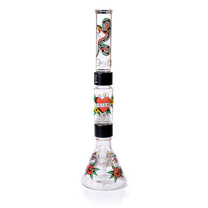 Front view of the Prism double stack beaker set-up , highlighting the clear 14mm  bowl and decal designs. The wide borosilicate glass base is visible, featuring an eagle and flower tattoo graphic. Image emphasizes the threaded glass connections, including the two black anodized aluminum Halo connectors linking the big tree perc chamber and the top mouthpiece. High quality, customizable two-stage smoking setup.