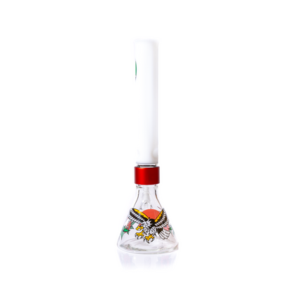 Rear perspective photograph of the custom glass water pipe, emphasizing the thick borosilicate glass fabrication and wide, stable base. View shows the connection point between the red connector piece and the white glass mouthpiece. Durable bong featuring unique tattoo-style graphic art (eagle). High quality smoking gear for advanced users.